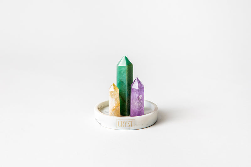 Aries zodiac star sign crystal set including amethyst, citrine and green aventurine crystals on a CRYST Collective white marble base. Buy crystals online at Cryst Collective.
