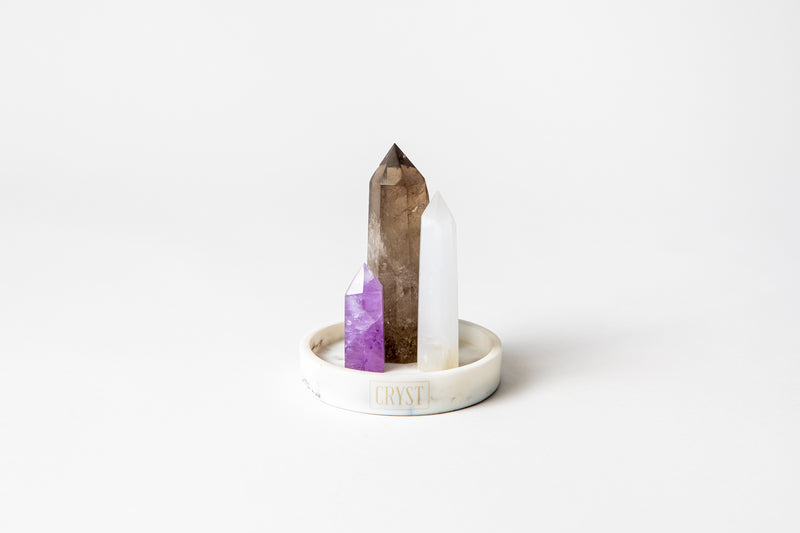 Calm Mind Trio crystal set including authentic amethyst (purple), selenite (white), smoky quartz (grey) crystal points on a CRYST Collective white marble base