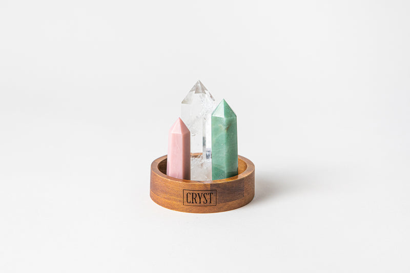 Calming and Healing Trio crystal set including clear quartz, green aventurine and pink opal crystals. These crystals work in synergy to calm the mind and heal the heart and reduces stress. On a CRYST Collective wood base.