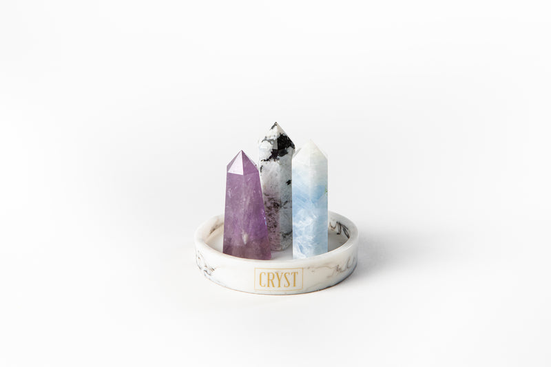 Cancer zodiac sign crystal set including blue calcite, rainbow moonstone and amethyst authentic crystals on CRYST Collective white marble base. Buy crystals online at Cryst Collective.