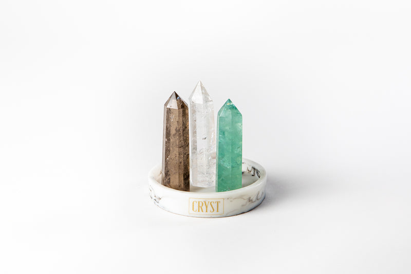 Capricorn zodiac star sign crystal set including Clear Quartz, Smoky Quartz and Green Fluorite crystals on a CRYST Collective white marble base. Buy crystals online at Cryst Collective and feel the benefits of crystals.