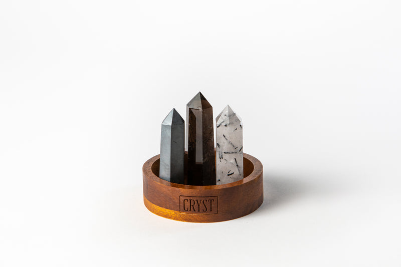 The Concentration and Grounding Trio crystal set including Smoky Quartz, Hematite and Tourmaline Quartz crystals on a CRYST Collective wood base. These crystals work in synergy to aid concentration, reduce stress and absorb electromagnetic pollution. CRYST Collective interior decor pieces Australia.