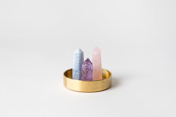 The Mothers Trio crystal set includes rose quartz, blue calcite and amethyst crystals. These crystals work in synergy to encourage self-love, self-compassion and facilitate open communication; comes on a CRYST Collective brass base. CRYST Collective modern interior decor pieces Australia.