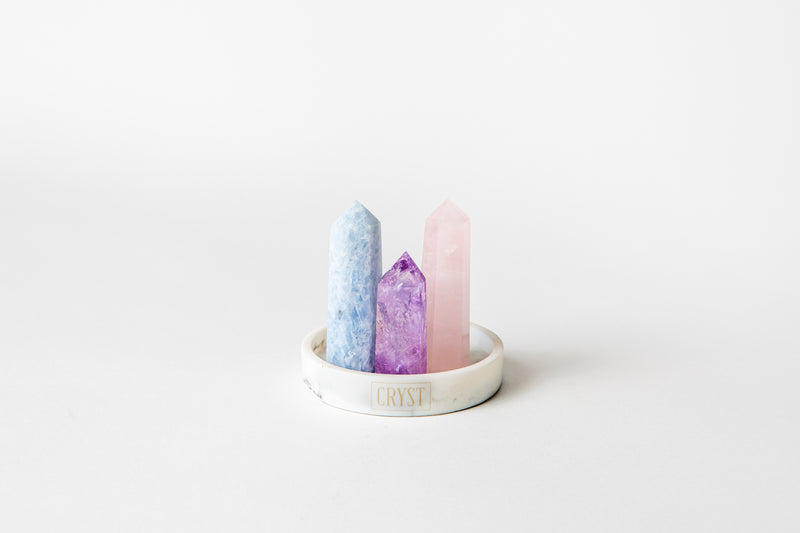 The Mothers Trio crystal set includes rose quartz, blue calcite and amethyst crystals. These crystals work in synergy to encourage self-love, self-compassion and facilitate open communication; comes on a CRYST Collective white marble base. CRYST Collective modern interior decor pieces Australia.