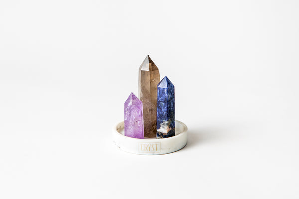 Sagittarius zodiac star sign crystal set including amethyst, smoky quartz and sodalite crystals on a CRYST Collective white marble base. Buy crystals online at Cryst Collective.