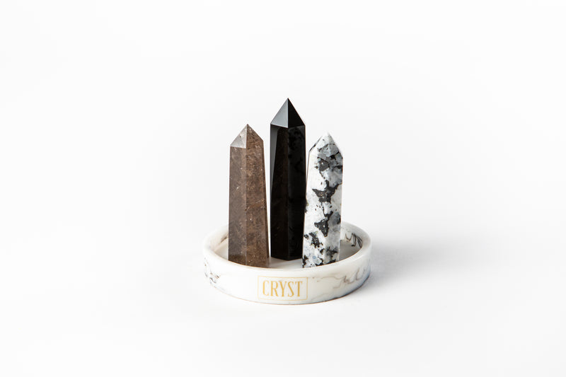 Scorpio zodiac star sign crystal set including Smoky Quartz, Onyx and Rainbow Moonstone crystals. These crystals work in synergy for the Scorpio star sign and comes on a CRYST Collective white base. Buy crystals online at Cryst Collective.