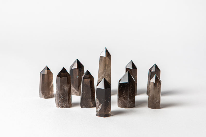Smoky Quartz crystal points  crystal benefits calms the mind, grounds energy, good for stress. Buy crystals online at Cryst Collective.